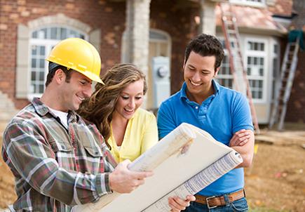 Experienced builder explaining construction plan to the couple